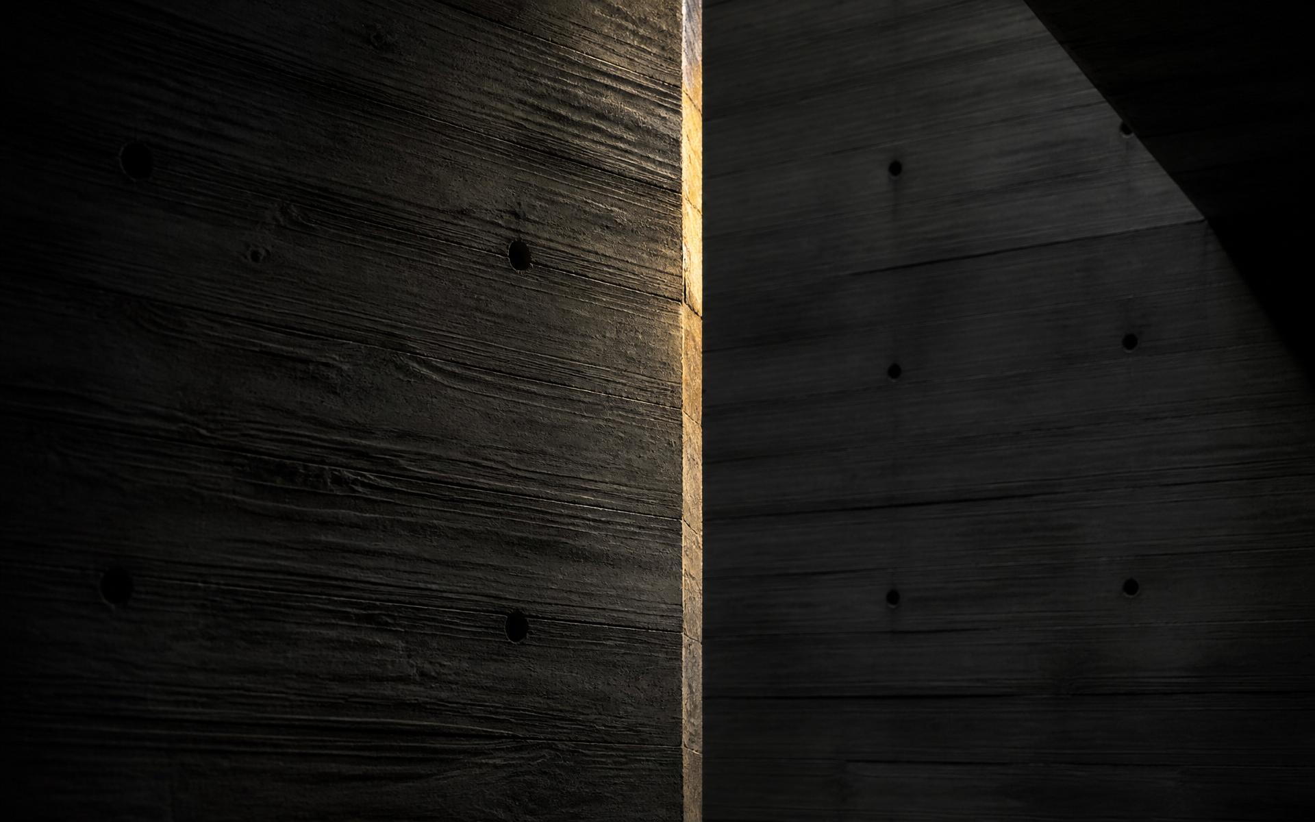 Board-formed concrete wall with amber light